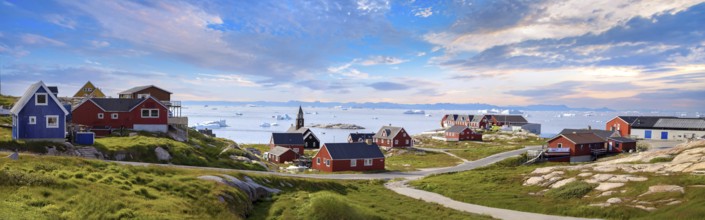 Typical architecture of Greenland Ilulissat with colored houses located near fjords and icebergs