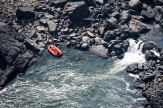 Rafting boat in the river, water plunging into the depths, Victoria Falls, Zambezi, Zimbabwe
