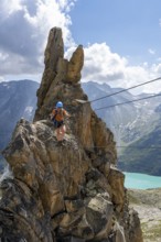 Crocodile rock formation, mountaineer on rope bridge in the Crocodile Mountain Lake via ferrata on