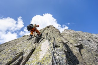 Mountaineers on the secure via ferrata Crocodile Mountain Lake at Bergseeschijen-Vorbau,