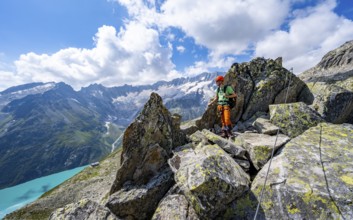 Mountaineers between boulders on the secured via ferrata Crocodile Mountain Lake at