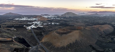 Picturesque volcanic landscape with volcanic craters Montaña de la Tabaiba at sunrise, Parque
