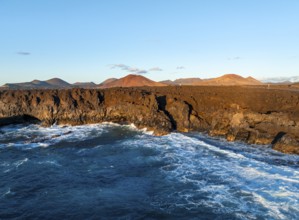 Coast with lava fields, volcanic landscape near Los Hervideros, in the evening light, aerial view,