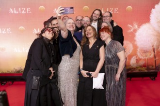 Guests take a group photo at the Cirque du Soleil Alizé world premiere at the Berliner Theater am