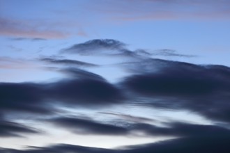 Blue sky with dramatic dark clouds at dusk, Peenetal nature park Park, Mecklenburg-Western
