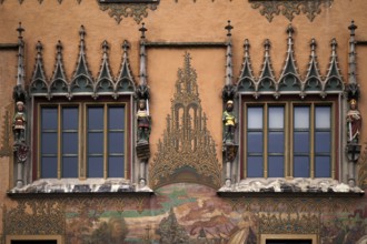 Painted façade with 4 medieval human sculptures, fresco cycle, window, town hall, old town, Ulm,