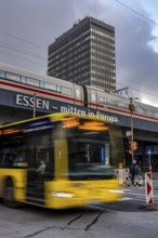 Ruhrbahn bus leaves the bus station at Essen main station, ICE train on track 1 in the train