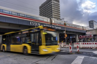 Ruhrbahn bus leaves the bus station at Essen main station, ICE train on track 1 in the train