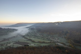 Sunrise with fog in the Neidlinger Valley with a view of the Reussenstein castle ruins. Swabian