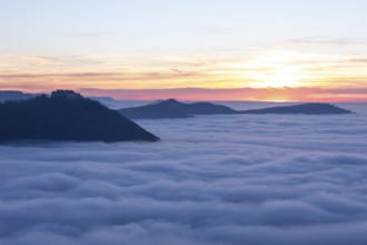 Sunset over the sea of fog from Beurener Fels to Hohenneuffen Castle, Swabian Alb,