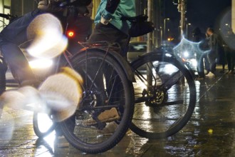 Cyclists in the evening in rainy weather in a city, Germany