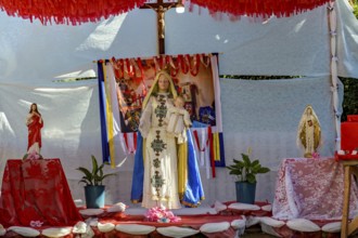 Colorful altar decorated with images of Catholic saints and the Virgin Mary