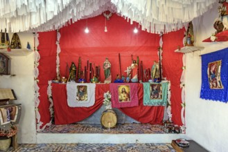 Altar in the interior of Brazil with objects, images of saints and entities from different