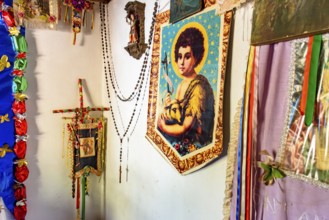 Religious objects on the wall of a simple and rustic house in the interior of Minas Gerais, Brazil