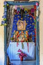 Altar inside a simple and rustic house in the interior of Minas Gerais, Brazil with objects, saints