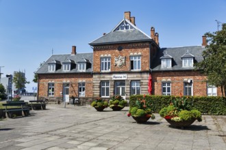 Rønne H, former main train station, café and hotel, historic brick architecture with coat of arms,