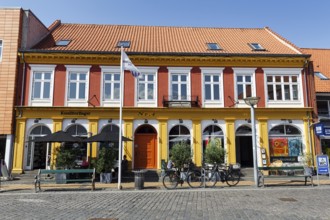 Building with bakery and outdoor seating, square in the old town of Rønne, Bornholm Island, Denmark