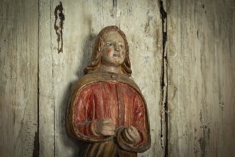 Carved wooden figure with red cape, Garmo Stave Church, Maihaugen open-air museum with houses and