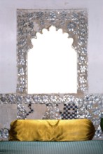 A window decorated with mirrors, including a cushion covered with shiny gold fabric, Karni Fort