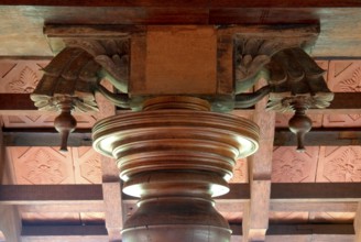Decorative wood structure with carved details on a ceiling, traditional architectural style, Kalari