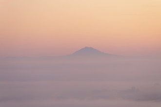 Hohenstaufen mountain in golden morning light, Aichelberg. Spectacular dawn over the foggy
