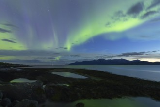 Northern lights at dawn over Sørfolda Fjord near Kjerringøy between Bodø and Sørfold in Norway