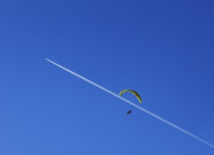 Paragliders with contrails in the blue sky, Osterhorn Group, Salzkammergut, Province of Salzburg,