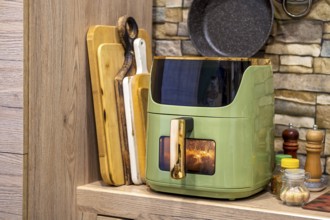 Delicious potato wedges cooking in an air fryer in a cozy kitchen setting