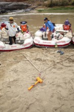 Loma, Colorado - An anchor holds rafts on the shore of the Colorado River during a river rafting