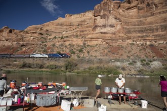 Loma, Colorado - Amtrak's California Zephyr passes a river rafters' campsite on the Colorado River