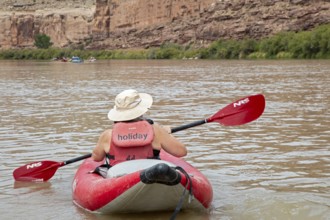 Loma, Colorado - A woman paddles an inflatable kayak, part of a river rafting trip on the Colorado