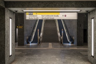 Escalators and signposts at the Museumsinsel subway exit in Berlin Mitte, Germany