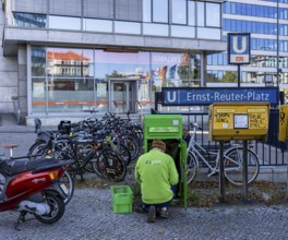 Pin Ag employees at a green mailbox in front of the subway entrance at Ernst Reuter Platz, Berlin,