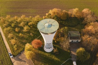 Autumn landscape with water tower and adjacent building, surrounded by nature, Möglingen water