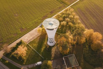 Water tower with surrounding autumn leaves, bordering fields in rural surroundings, Möglingen water