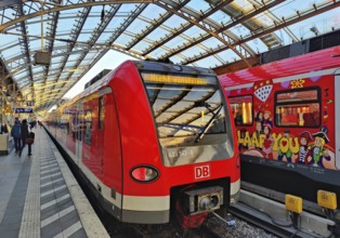 Central Station early in the morning with regional express and S-Bahn with carnival design,