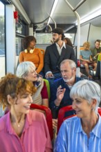 Multiethnic, multi generational passengers seated inside a city bus, chatting and commuting
