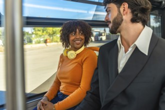 Couple chatting and smiling on a city bus, relaxed commuters sharing a warm, candid moment during