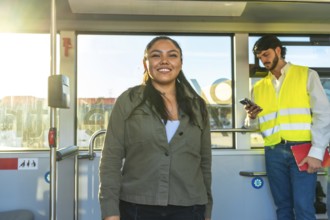 Smiling young woman standing inside a city bus during her daily commute, enjoying the ride while a