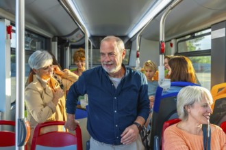 Diverse group of people, including seniors and children, commuting and traveling together inside a