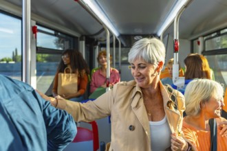 Diverse group of women commuters chatting and smiling on a city bus, enjoying a daytime ride
