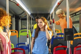 Diverse commuters stand and ride a bright city bus, holding handrails and chatting as they travel