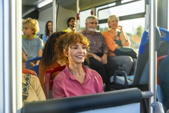 Diverse group of smiling passengers men, women, children and seniors relaxed and chatting on a