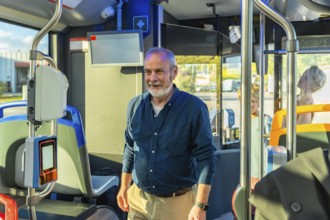 Senior man smiling while riding a public transport bus, representing urban commuting, sustainable