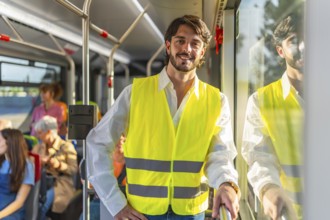 Young man wearing a bright yellow safety vest and white shirt, smiling at the viewer while