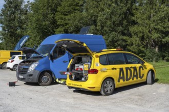 ADAC Strassenwacht vehicle in a parking lot, opened trunk with tools, jump starter for a delivery