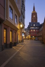 The lights in the shops of Frankfurt's New Old Town and the top of St. Bartholomew's Cathedral glow