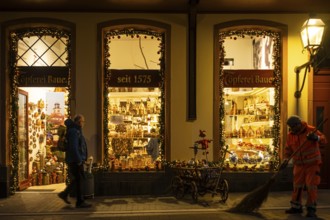 At Christmas time, a passerby walks past a souvenir shop in Frankfurt's New Old Town, while an FES