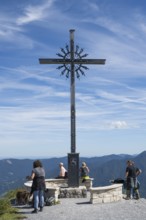 Summit cross with tourists, Brauneck 1555m, Bavarian Prealps, Isarwinkel, Lenggries, Upper Bavaria,