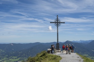 Summit cross with tourists, Brauneck 1555m, Bavarian Prealps, Isarwinkel, Lenggries, Upper Bavaria,